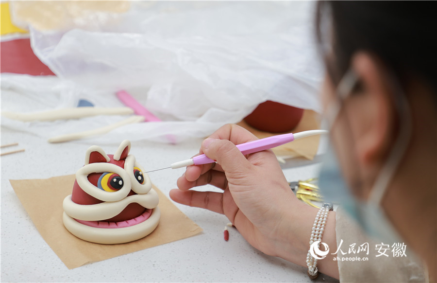 高斯雅為“醒獅”花饃點(diǎn)睛。人民網(wǎng)記者 王曉飛攝
